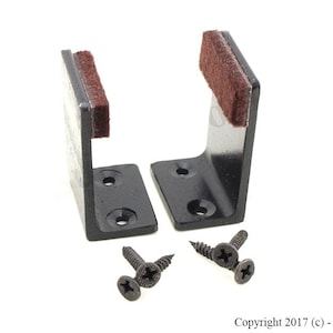 May include: Two black metal shelf brackets with brown felt pads on the bottom. Each bracket has two screw holes and comes with two black screws.