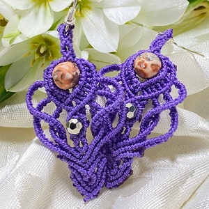 May include: Purple macrame earrings with a brown and white agate bead and silver accents.