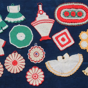 May include: A collection of fourteen assorted crochet potholders and decorative mats in various shapes and sizes. The items feature red, white, green, and yellow yarn patterns, including dress-shaped, circular, oval, and hexagonal designs.