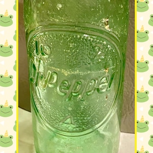 Dr. Pepper Green tinted Glass Bottle with Unique Marketing’s on the Bottom. A RARE collectible addition!
