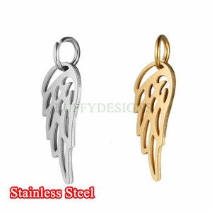 May include: Two angel wing charms, one silver and one gold. Both charms have a loop at the top for attaching to a necklace or bracelet.  The charms are made of metal and have a detailed design.