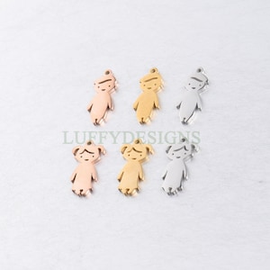 May include: Six metal charms in the shape of a person. The charms are in three different colours: gold, silver, and rose gold. The charms are all the same size and shape, and they are all facing the camera. The charms are on a white background.