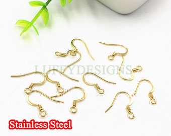 May include: Gold-toned earring hooks made of stainless steel. The hooks are designed with a small loop at the top and a curved wire that forms a hook.