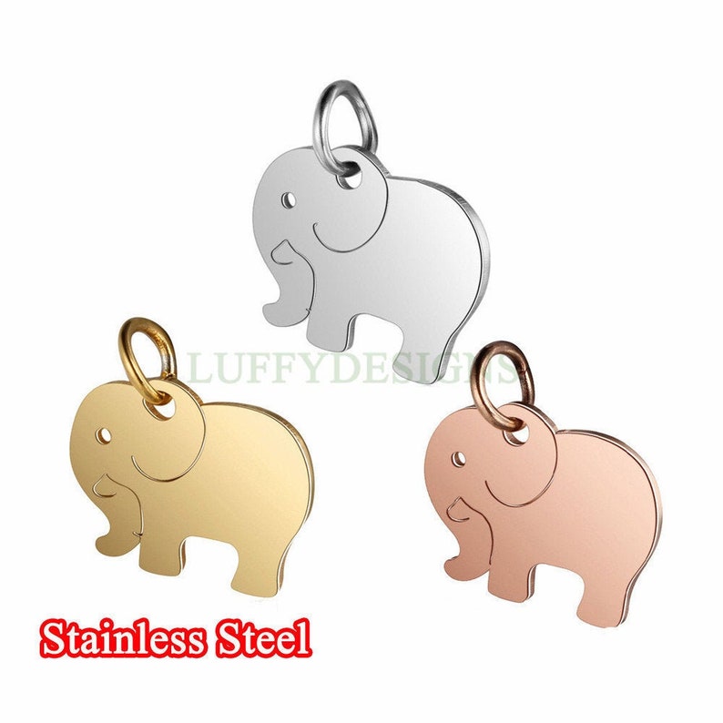 May include: Three stainless steel elephant charms in silver, gold, and rose gold. Each charm features a simple elephant design with a loop for attaching to a necklace or bracelet.