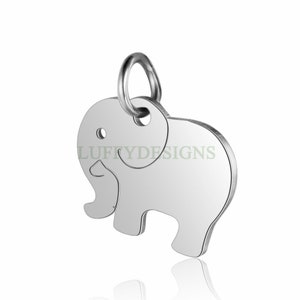 May include: Silver charm in the shape of an elephant with a loop at the top for attaching to a necklace or bracelet.