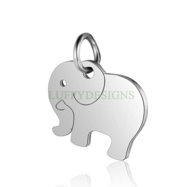 May include: Silver charm in the shape of an elephant with a loop at the top for attaching to a necklace or bracelet.