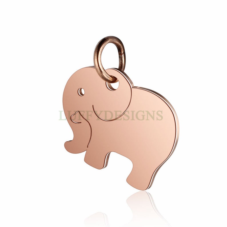 May include: Rose gold elephant charm with a loop for attaching to a necklace or bracelet. The charm is a simple silhouette of an elephant with a smooth, polished finish.