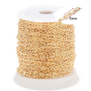 May include: A spool of gold-coloured chain, 2 mm in width. The chain is wound around a white plastic spool.