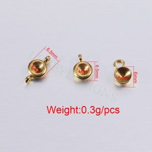 May include: Three gold-toned metal pendant settings with a round, slightly domed top. The settings are 6.5 mm in diameter and weigh 0.3 grams each.  Weight: 0.3g/pcs