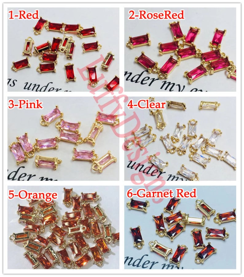 May include: Assortment of 10mm gold-tone metal connector charms with various colored crystal stones. The colors include red, rose red, pink, clear, orange, and garnet red.