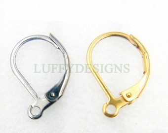 May include: Two leverback earring findings, one silver-colored and one gold-colored, are displayed against a white background. The text "LUFFYDESIGNS" is visible in the background. These findings are used for making earrings.