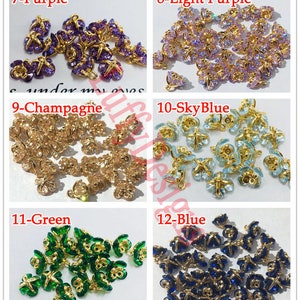 May include: Assortment of 10 butterfly charms with gold-tone metal settings and various colored crystal accents. The charms are labeled with numbers and colors: 7-Purple, 8-Light Purple, 9-Champagne, 10-Sky Blue, 11-Green, and 12-Blue.