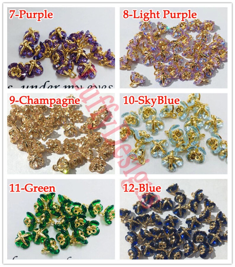 May include: Assortment of 10 butterfly charms with gold-tone metal settings and various colored crystal accents. The charms are labeled with numbers and colors: 7-Purple, 8-Light Purple, 9-Champagne, 10-Sky Blue, 11-Green, and 12-Blue.