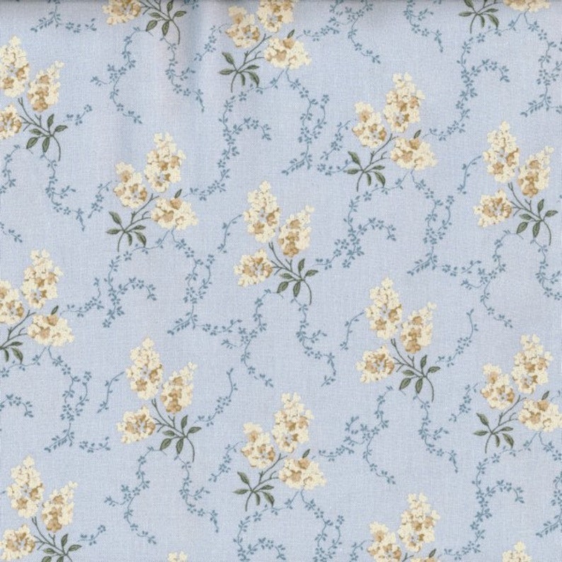 May include: A light blue fabric with a repeating pattern of small white flowers and delicate blue vines.