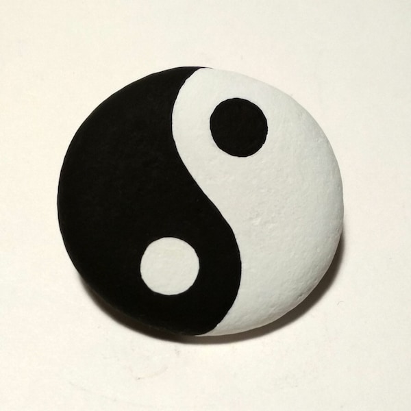 Symbole yin yang peint à la main à l'acrylique sur un galet naturel rond provenant de la mer, recouvert de vernis satiné pour la protection