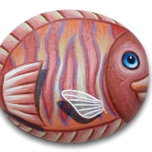 Striped fish in orange shades hand painted on pebble. Stone painting art with acrylics and finished with satin varnish. painted rock fish.