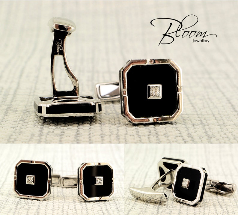 May include: Silver cufflinks with a black square center and a small square diamond. The cufflinks have a geometric design and are displayed on a textured surface. The Bloom Jewellery logo is visible in the upper right corner.