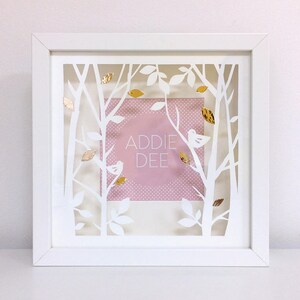 May include: White frame with a cutout design of trees and leaves. The frame has a pink background with white polka dots and the text "ADDIE DEE" in a circle. There are gold accents throughout the design.