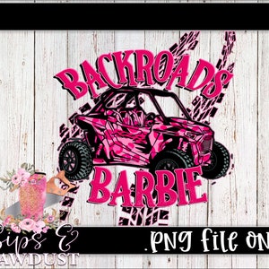 May include: Pink and black graphic design featuring a pink and black camouflage off-road vehicle with the text "Backroads Barbie" in pink letters.