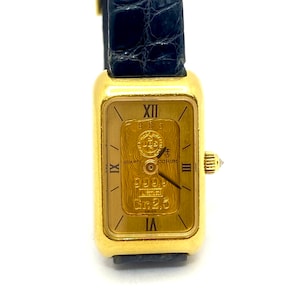 Mint Lady's Corum Swiss Quartz Wrist Watch with 24K gold ingot and 18K yellow gold.