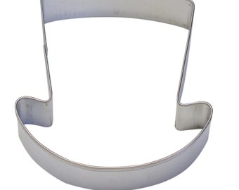 May include: A silver metal cookie cutter shaped like a top hat.