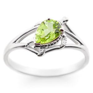 May include: A silver ring with a pear-shaped green gemstone set in a turtle design.