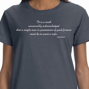May include: A dark blue t-shirt featuring a white quote from Jane Austen: "It is a truth universally acknowledged that a single man in possession of good fortune must be in want a wife."