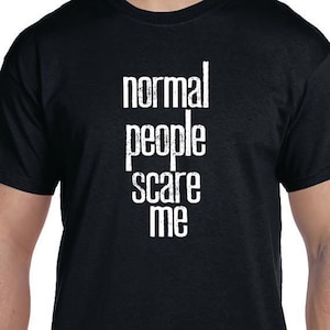May include: Black t-shirt with white text that reads "normal people scare me".