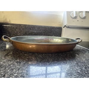 May include: A set of three ceramic mugs with a speckled, matte finish. The mugs are in shades of cream, light gray, and dark gray. Each mug has a simple, minimalist design and a rounded handle.