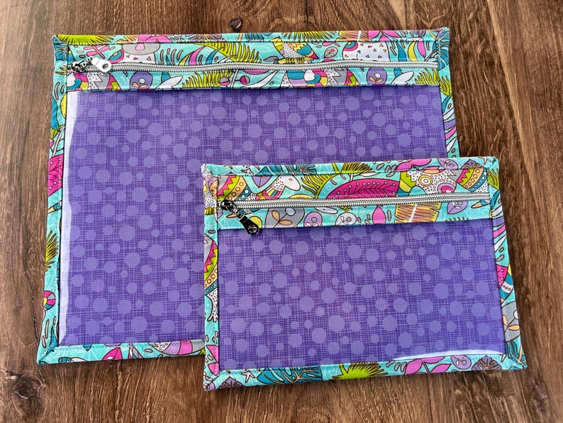Puede incluir: Dos bolsas con cremallera, una grande y otra peque&ntilde;a, con frente transparente y un estampado de lunares morados. Los bordes est&aacute;n ribeteados con una tela colorida con dise&ntilde;os caprichosos y un fondo turquesa. Las cremalleras son plateadas.