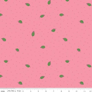 May include: A pink fabric with a repeating pattern of green leaves. The leaves are outlined in black and have a white center. The fabric is speckled with tiny white dots.
