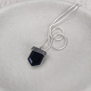 Black onyx pendant crafted from sterling silver on a snake chain.