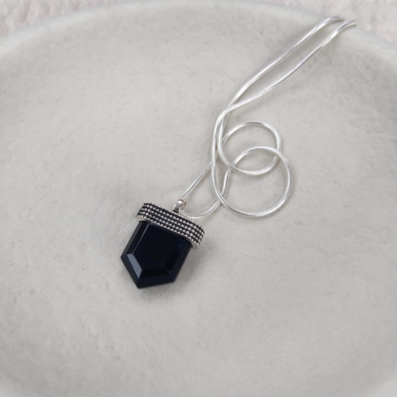 Black onyx pendant crafted from sterling silver on a snake chain.