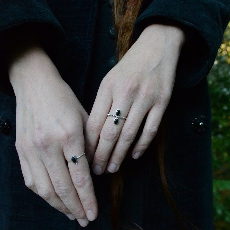 dainty black onyx sterling silver rings on model