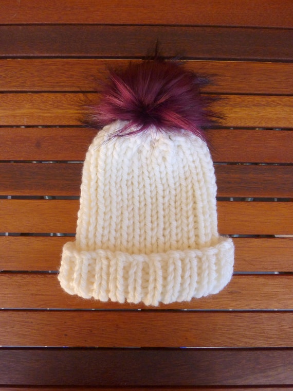 cream hat with fur pom pom