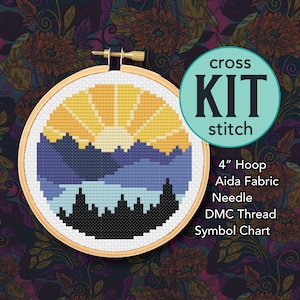 May include: Cross stitch kit featuring a sunset over a city skyline. The kit includes a 4-inch hoop, Aida fabric, needle, DMC thread, and a symbol chart.