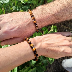 Unisex adjustable bracelet made from natural 8mm tiger eye beads for protection, confidence and grounding