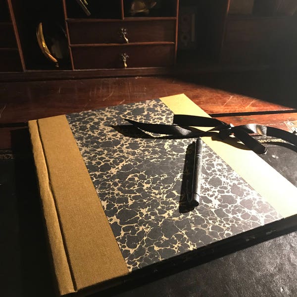 Handmade Portfolio with writing paper covered in marbled paper and linen