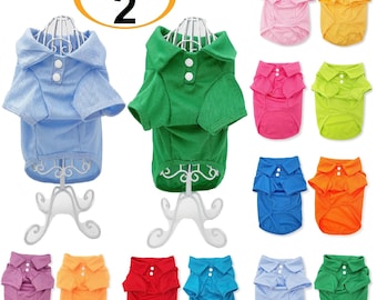May include: A pack of two dog polo shirts in blue and green, displayed on white stands. Additional shirts in pink, yellow, fuchsia, lime green, blue, orange, purple, red, and light blue are also shown. Each shirt has a collar and two buttons.
