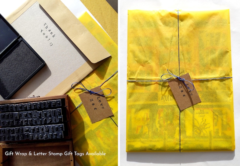 May include: A yellow gift wrap with a blue ribbon and a brown gift tag that says "Love Zac". The gift wrap is on a white surface. The gift tag is tied to the ribbon with a blue string. The gift wrap is made of tissue paper. The gift tag is made of brown paper. The gift tag is tied to the ribbon with a blue string. The gift wrap is on a white surface.