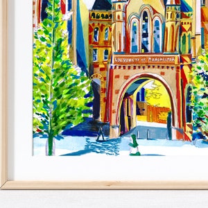 May include: A watercolor painting of a university building with a large archway and the text "University of Manchester" above it. The building is painted in bright colors, including red, yellow, and blue. There are two trees on either side of the archway, and a person walking through the archway.
