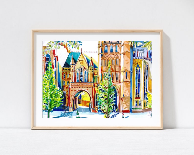 May include: A watercolor painting of a colorful building with a large archway. The building is surrounded by trees and has a white background. The building has a red roof and yellow walls. The archway is made of brick and has a stone arch. The trees are green and have brown trunks. The painting is framed in a light wood frame.
