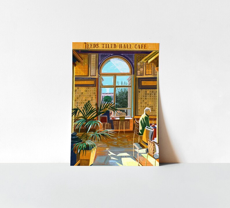 May include: A vintage postcard featuring a cafe interior with a large window, tiled walls, and a person sitting at a table. The text "Leeds Tiled Hall Cafe" is printed at the top of the postcard.