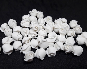 May include: A pile of white foam rose buds, perfect for crafting and decorating.