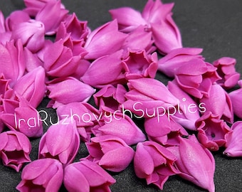 May include: A large pile of small, bright pink, fabric flower buds. The flower buds are arranged in a random pattern. The text "Ira Ruzhovich Supplies" is visible in the image.