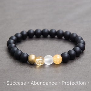 May include: Black beaded bracelet with gold, white and yellow beads.  "Success, Abundance, Protection"