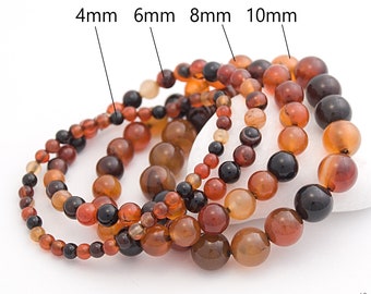 May include: Four carnelian gemstone bracelets in different sizes: 4mm, 6mm, 8mm, and 10mm. The bracelets are made of round, smooth beads in shades of red, orange, and brown.