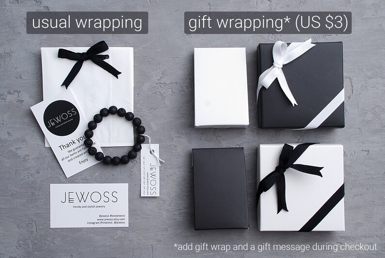 May include: Two options for wrapping a gift: a white paper bag with a black ribbon and a black and white gift box with a white ribbon. The gift box is available for an additional $3. The image also includes a black lava rock bracelet and a business card with the text "JEWOSS" on it.