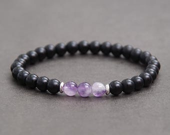 May include: Black beaded bracelet with three amethyst beads and silver spacers. Protection, Happiness, Removes Negativity.