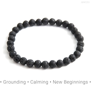 May include: Black lava rock beaded bracelet. The bracelet is made of small, round beads that are strung together on a stretchy cord. The beads are a dark gray color and have a rough, textured surface.